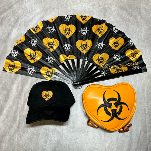 Black cap, black folding fan with biohazard symbols, and orange heart-shaped object with biohazard symbol on a gray background.